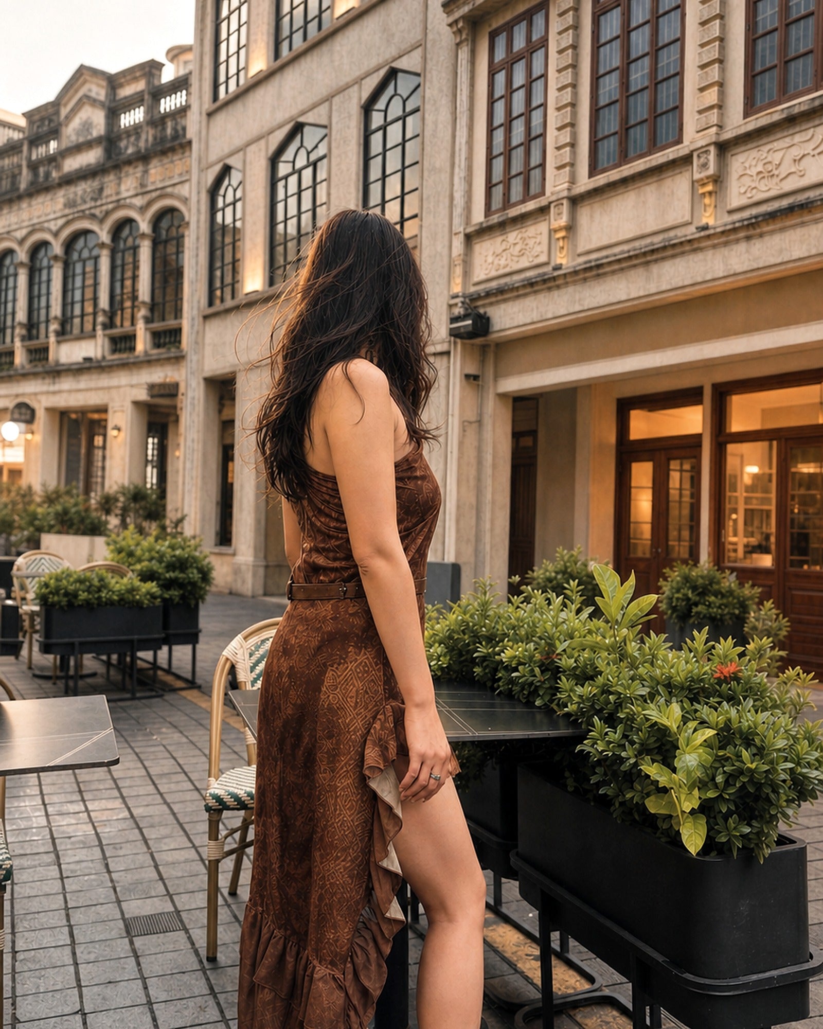 Side view showing the high-low ruffled hem of the Nomad Tide dress in Tobacco Brown