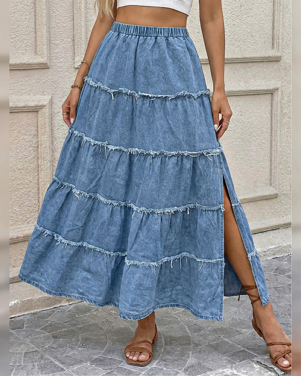 Front view of the light blue raw-edge tiered denim maxi skirt